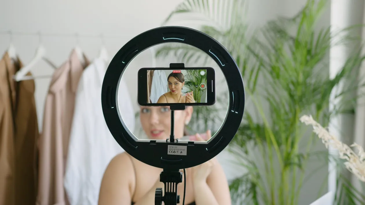 A woman video recording herself using a phone
