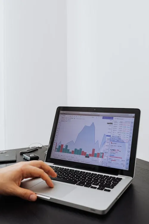 A person using a laptop to analyze data