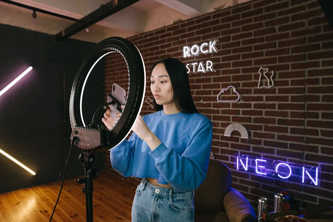 A woman using her phone attached on a ring light